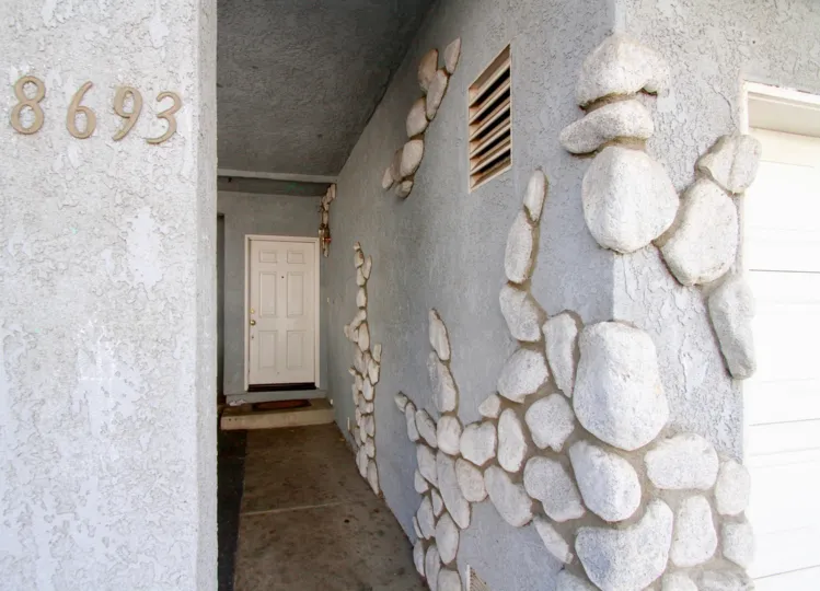 Cypress West II Cypress California wall contains large stone designs in front and number at other side