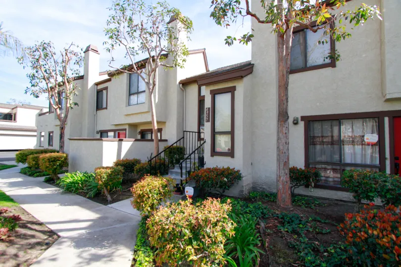 A HOUSE WITH CUTE GARDEN SURROUNDING AND STEPS THAT MEANS RAMP ALSO THERE AT THE MORNING SUNSHINE TIME
