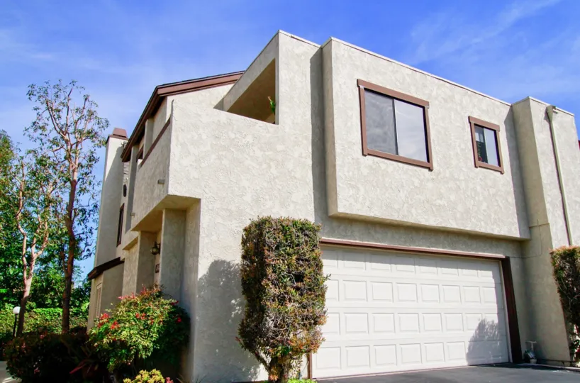 Multiple story townhomes with large windows in California.
