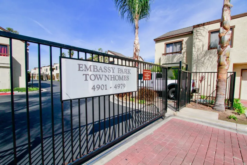 Embassy Park Townhomes Cypress California have long security grid and sign board at front