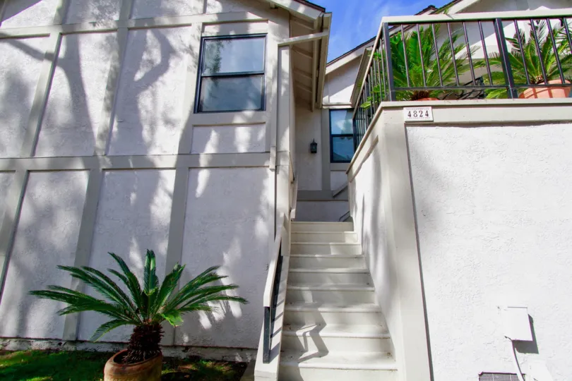 The stairs leading to a unit in Influential Townhomes on a sunny day