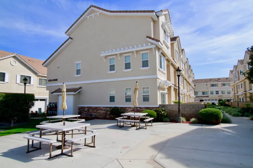 Large housing surrounded by tables in the community