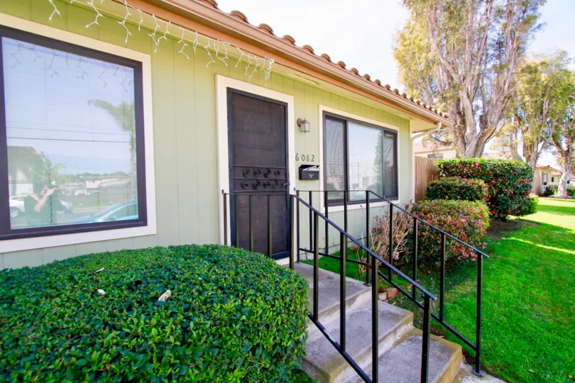 THE BUILDING WITH DIFFERENT COLOR AND THE WINDOW DECORATE WITH CUTE WALL AND SOME STEPS ALSO AVAILABLE NEAR TO THE DOOR SOME PLANTS ALSO NEAR TO THE HOUSE