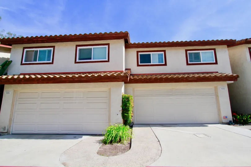 The garages and upper story windows of a building in Palm Park