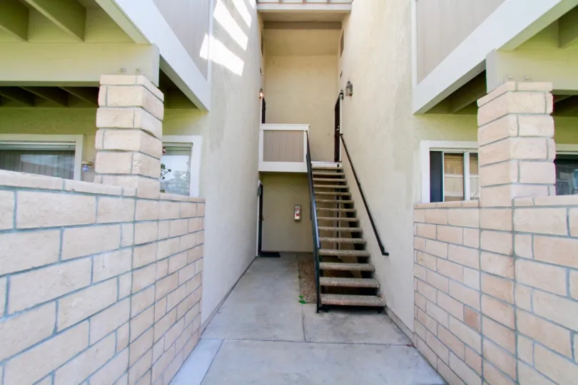 THE HOUSE WITH STEPS AND LOOKS LIKE LITTLE INSIDE AND THE WALL ALSO LOOKS NEW AT THE MORNING TIME