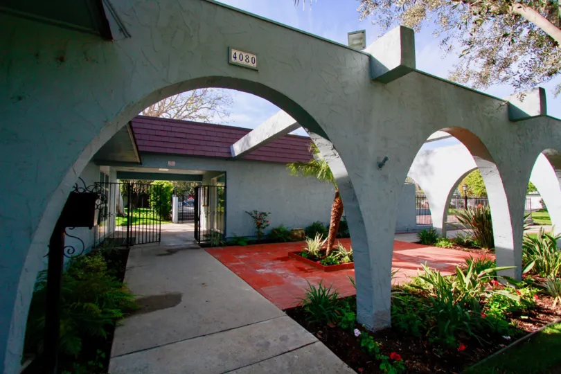 A sunny day in the Tanglewood West front gate with a beautiful garden