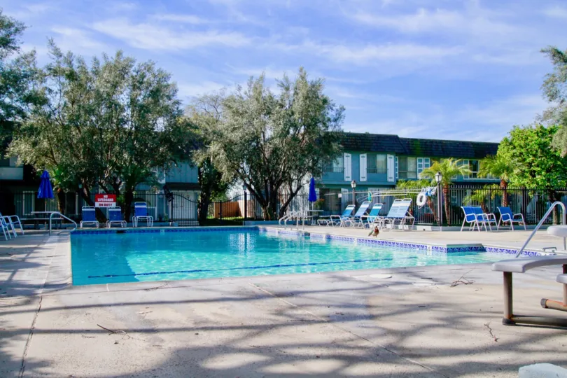 A SWIMMING POOL WITH SOME REST CHAIRS AND PLANTS ALSO AVAILABLE AND A GOOD RESTAURANT ALSO SURROUNDING THERE