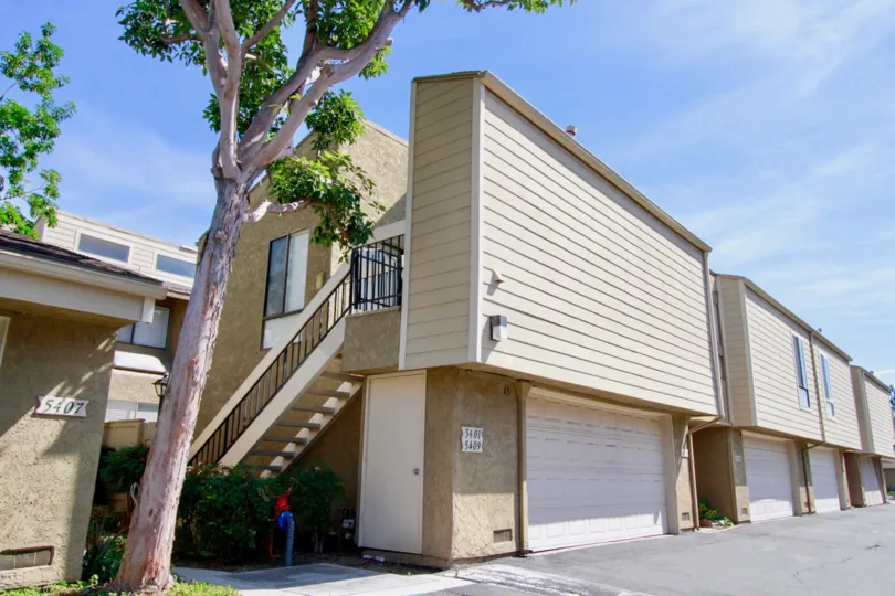 A garage and row of units in the Twin Lakes community on a sunny day