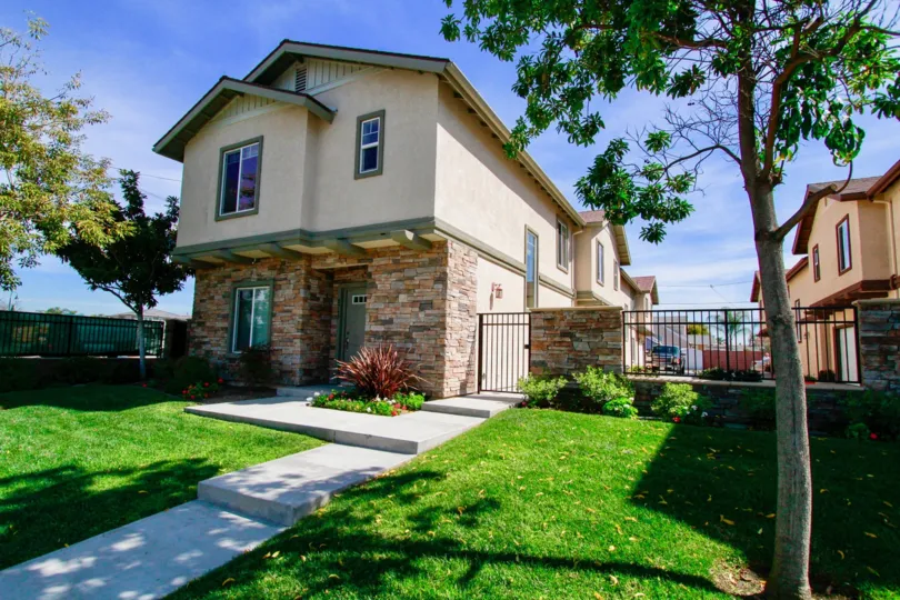 A sunny day at a beautiful house with a well-cared front yard in the Villa Saint Ann neighborhood.