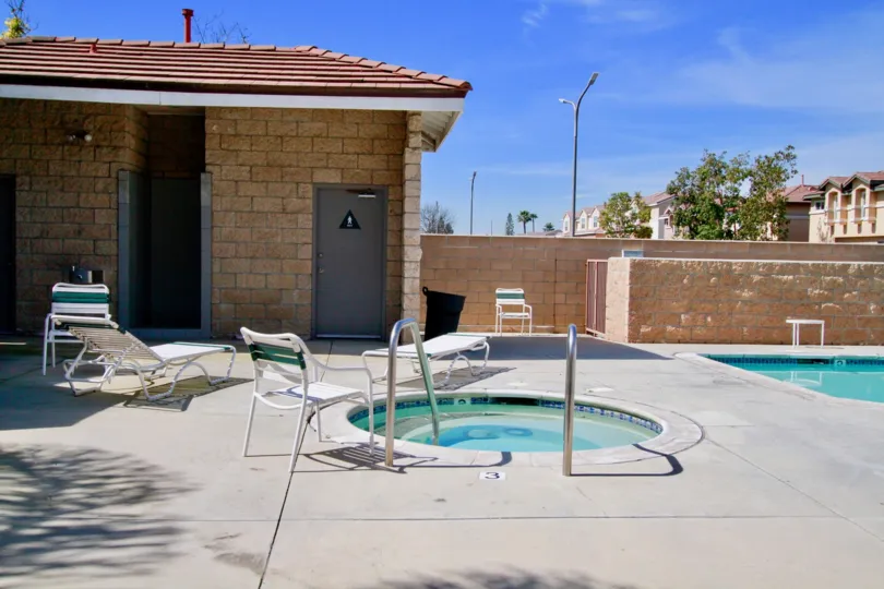 A POOL WITH SMALL AND BIG SIZE AND A HOUSE ALSO THERE AT THE MORNING AND CHAIR ALSO NEAR TO THERE AND TREES PLANTS ALSO THERE