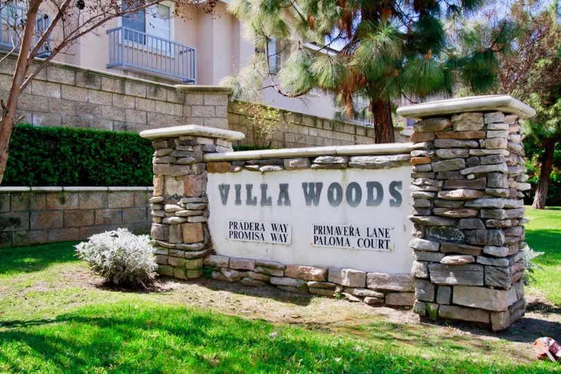 The neighborhood sign for VIlla Woods in Cypress on a sunny day