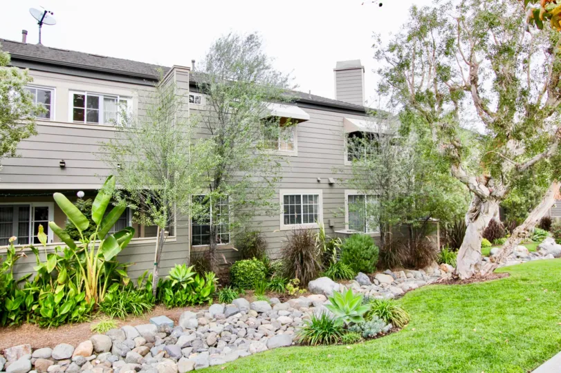 Place which has An apartment, trees, rocks near the meadow and plants near the Apartment in Bluffside Villas