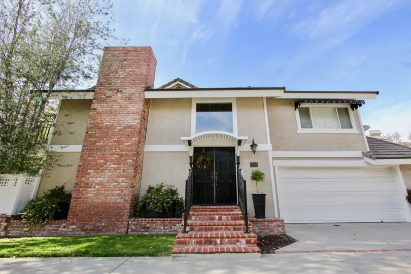 a warm day in the camino heights with house that has stone walls and short step