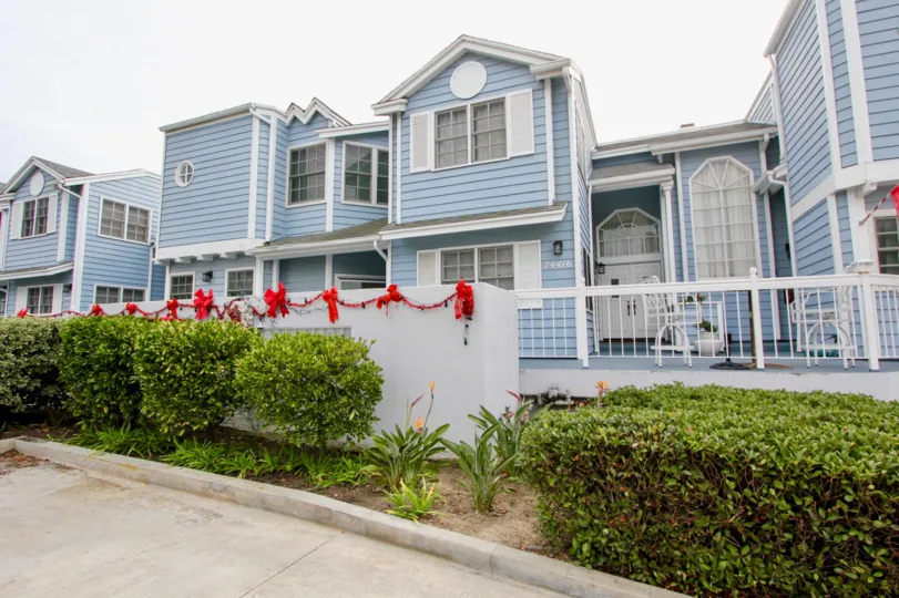 a warm day in the dana by the sea with house that has roof top circle and garden in entrance