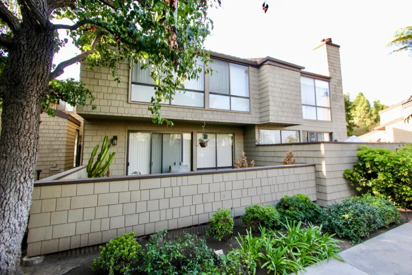 a warm day in the Dana Terrace with house that has glass window and stone walls