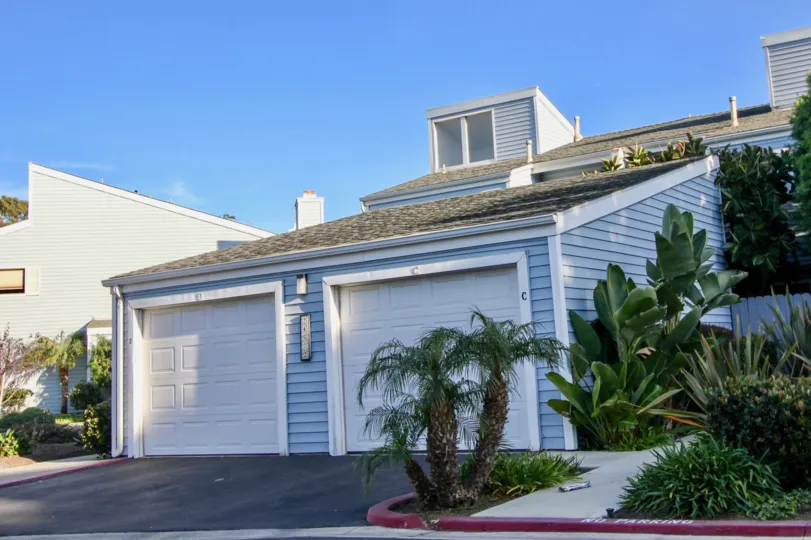 a pleasent day in the dana vista with house that has roofless top and closed parking door on garden