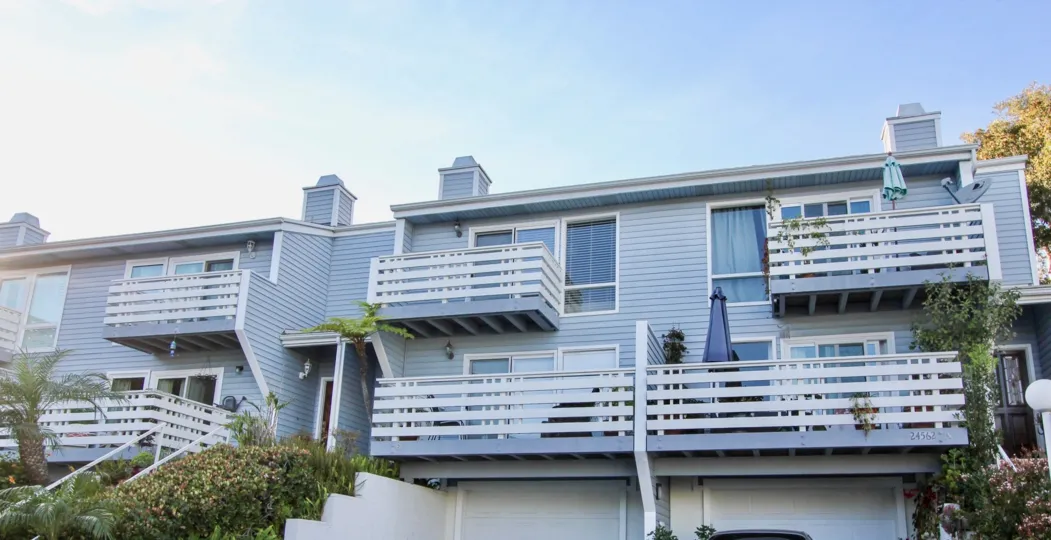a warm day in the dana vista with house that has 5 storey and glas windows