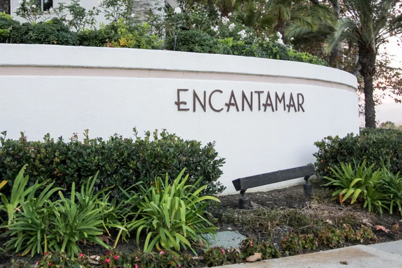 a warm day in the encantamar with building that has garden in front