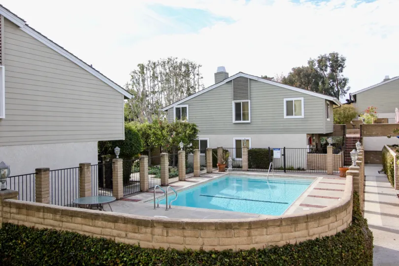 a sunny day in the golden lantern villas with building that has swiming pool and 8 walls