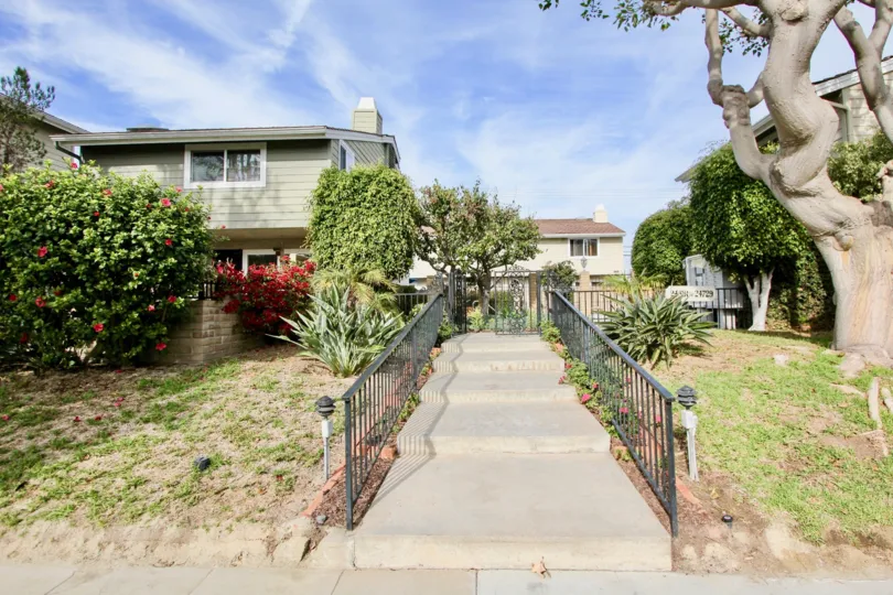 a warm day in the golden lantern villas with house that has short steps and garden in left