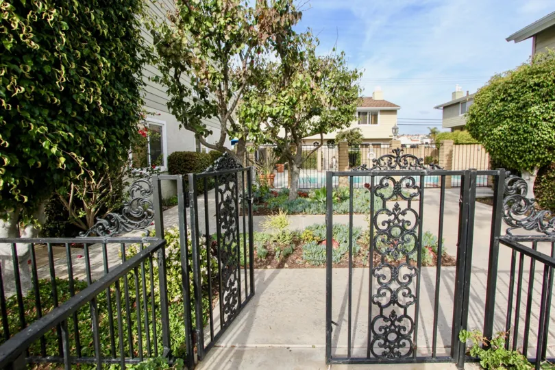 a sunny day in the golden lantern villas with house that has outway gate and the garden