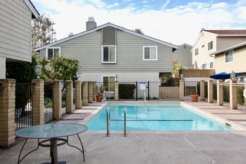 Poold side view with table in Golden Lantern Villas community, Dana Point, CA