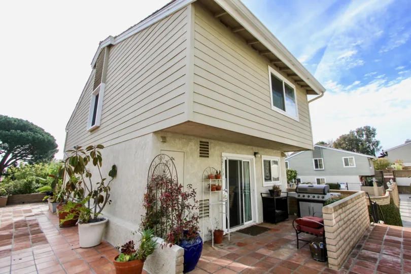 a warm day in the golden lantern villas with house that has glass window and stone walls