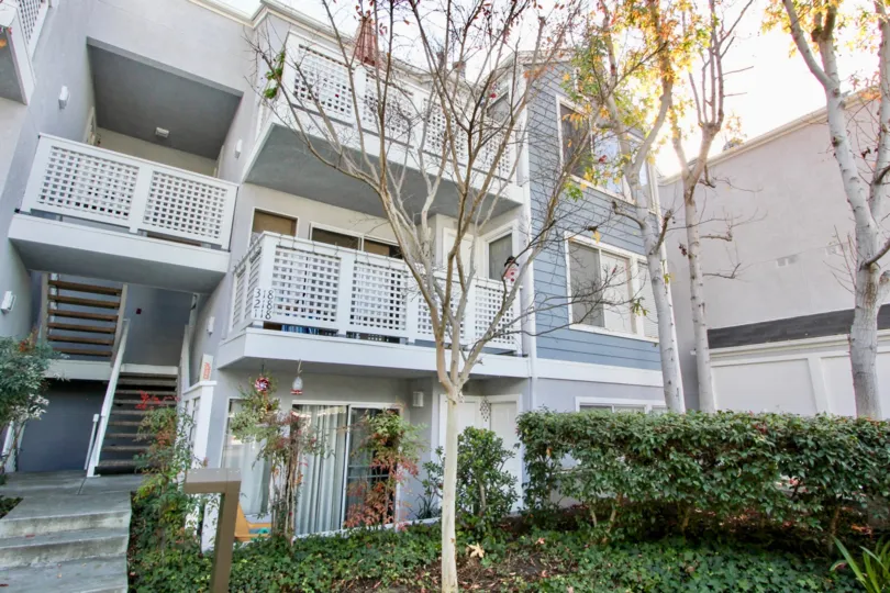 Side view with front small garden and trees of Harbor Walk community, Dana Point, CA