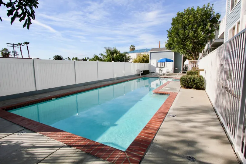 a sunny day in the harbor walk with a swiming pool that has blue clear water and a umberrla