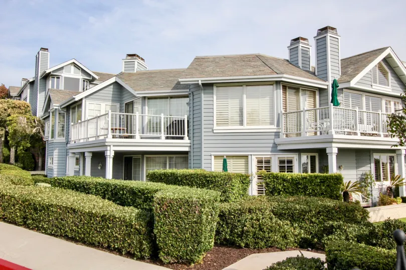 Front view with veranda and windows of Lantern Bay Villas community, Dana Point, CA