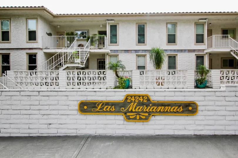 a pleasant day in the Las Mariannas with a white coloured building that is numbered as 24242