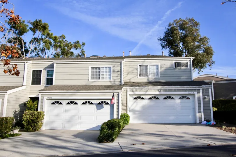 THE HOUSE IN THE MARINITA TOWNHOMES WITH THE FLAG, SHUTTER, PLANTS