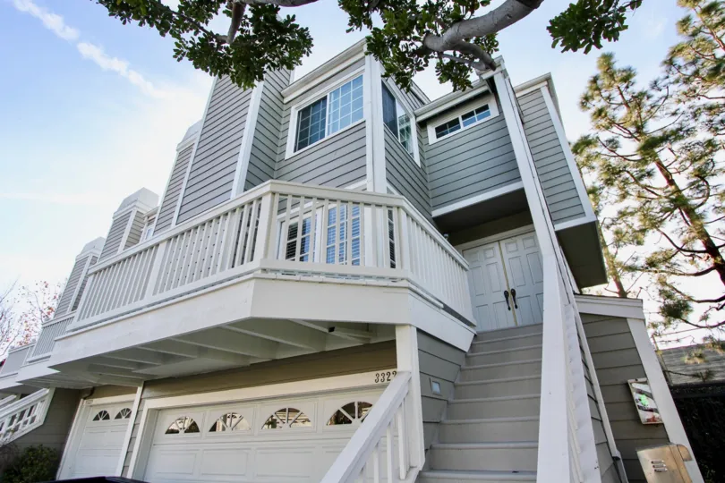 Side view with trees and staircase of Marinita Townhomes, Dana Point, CA
