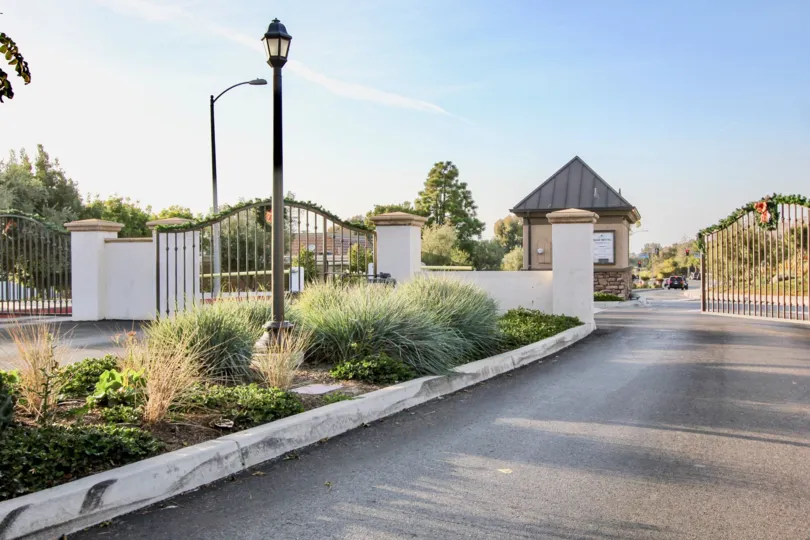 Gate is open in Niguel Shores with light lamp and bushes of city Dana Point