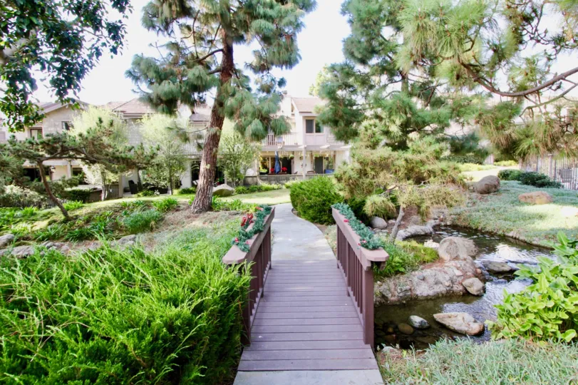 A great day in the Old Mill Pond with a garden in front of a building.