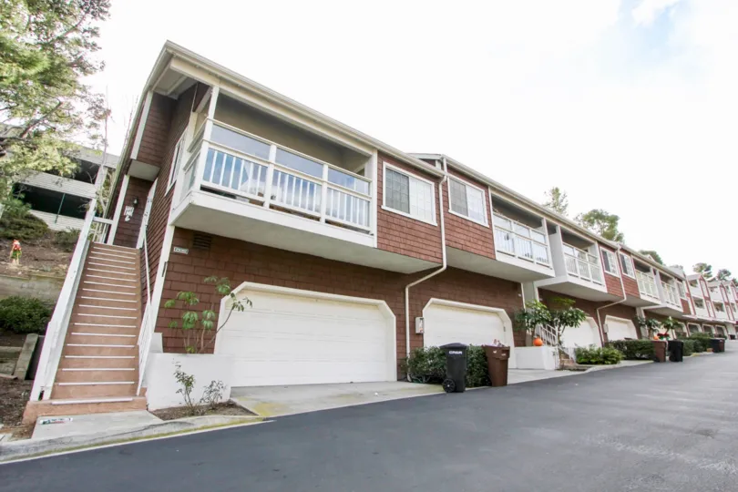 Side view with staircase and garage doors of Pacific Terrace community, Dana Point, CA