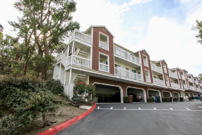a warm day in the pacific terrace with a building that has parking at the ground floor with clear road