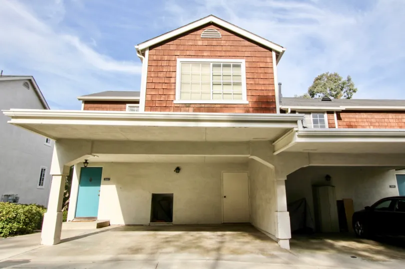 a sunny day in the pacific terrace with house that has parking in front with a car parked