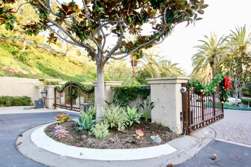a warm day in the ritz pointe with house that has out gate and garden around