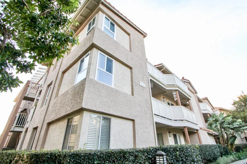 a warm day in the ritz pointe with house that has glass window and garden around