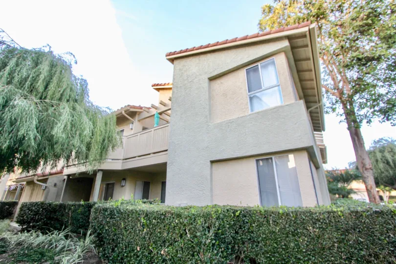 a warm day in the ritz pointe with house that has glass window and garden around