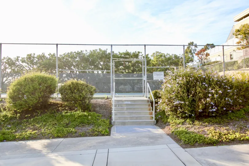 The way to the stairs of Swimming pool in Sea Ridge has plants with Flowers