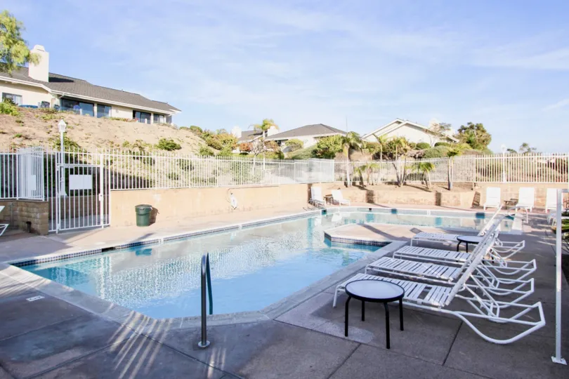 Long Swimming Pool with Chairs and dustbin placed in Sea Ridge