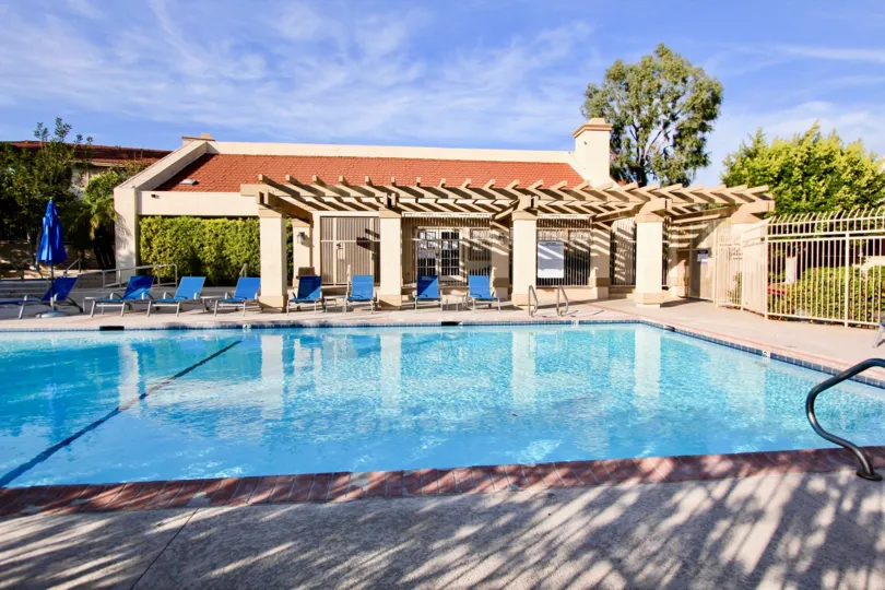 Pool area with chairs of Seaside Villas community, Dana Point, CA