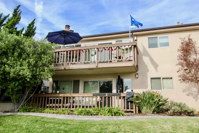 THE BUILDING IN THE SPINDRIFTER CONDOS WITH THE LAWN, PLANTS, UMBRELLA