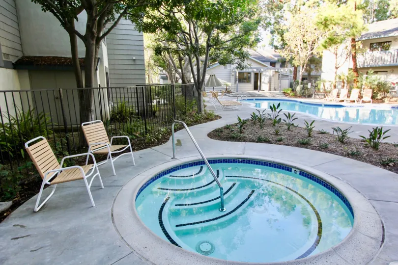 a sunny day in the spinnaker run with a building that has two swiming pool big and a small
