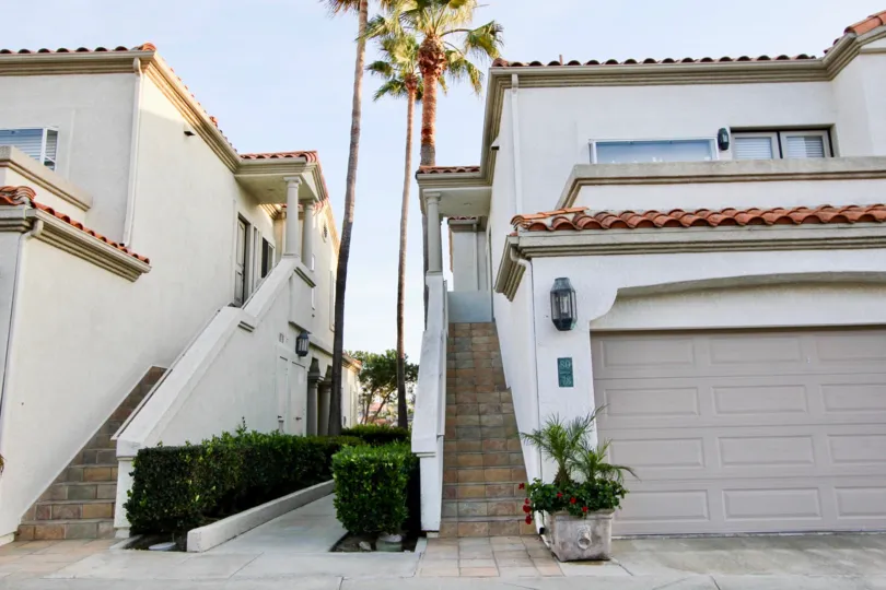 A great day in the Tennis Villas with some palm trees nearby two houses.