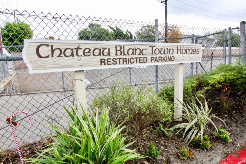 Chateau Blanc Fountain Valley California sign board with stands and restricted steel valley at back