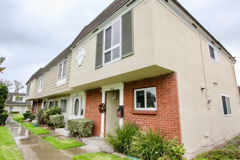 Chateau Blanc Fountain Valley California big house blocks with tiny trimmed grass meadows and brick wall