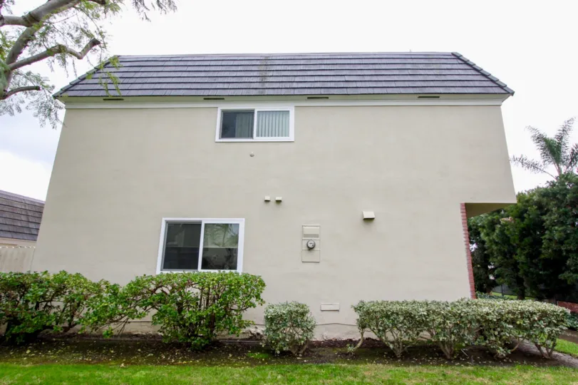 Chateau Blanc Fountain Valley California with huge wall and nice color roof at top with lines